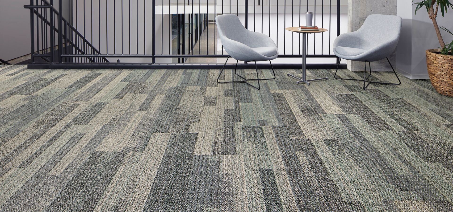 Interface Moving Tints plank carpet tile in stairwell landing