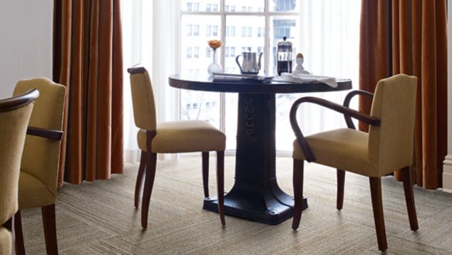 Interface NF400 plank carpet tile at small breakfast table in front of window