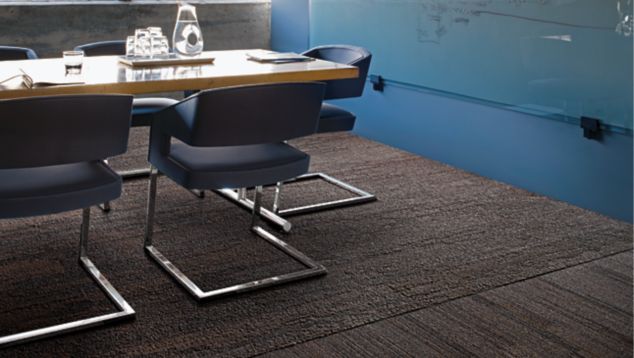 Interface NF400 and NF401 plank carpet tile in office meeting room with light shining through window