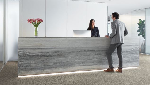 Interface Night Flight carpet tile in office lobby with man talking to receptionist