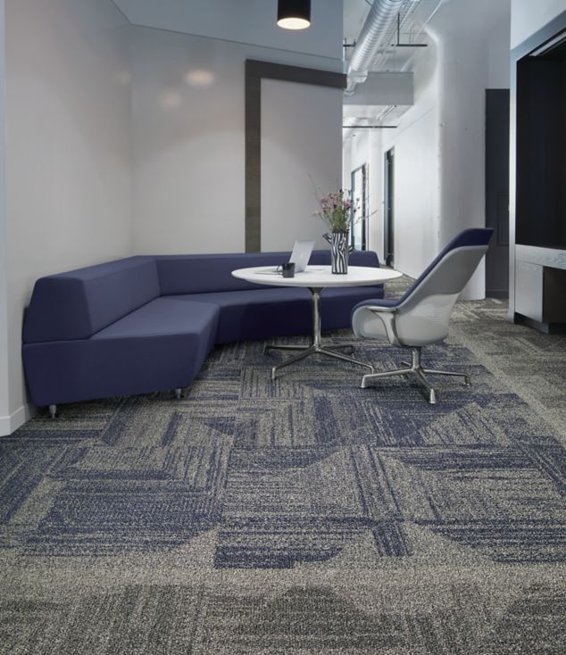 Interface Open Air 403 carpet tile with rounded blue corner bench with flower vase on table