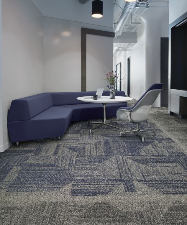 Interface Open Air 403 carpet tile with rounded blue corner bench with flower vase on table