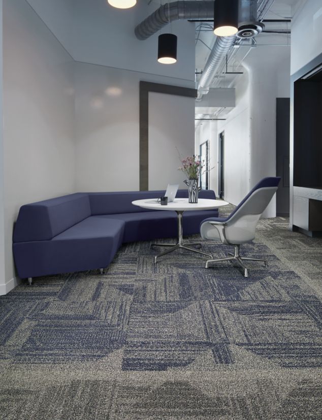 Interface Open Air 403 carpet tile with rounded blue corner bench with flower vase on table