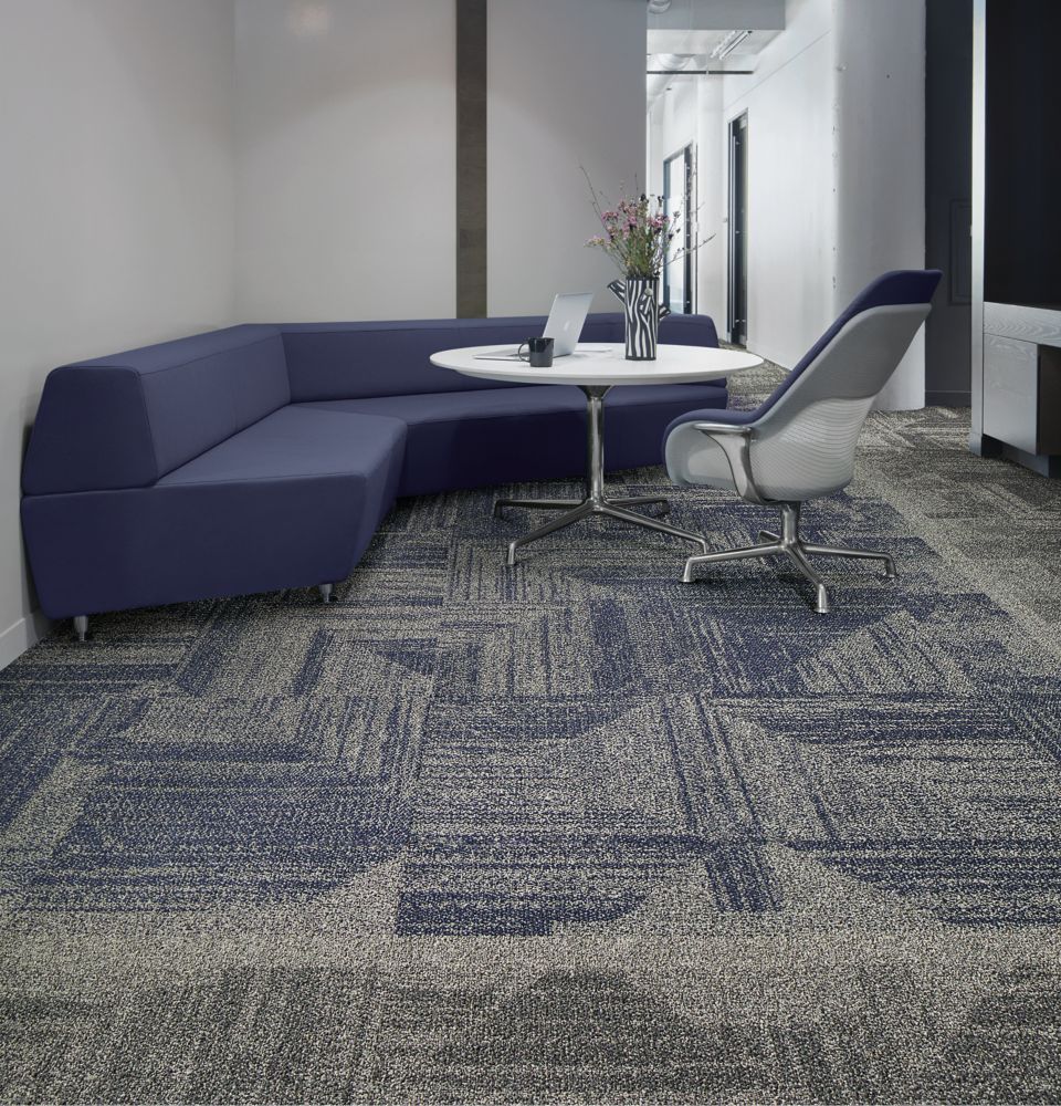 Interface Open Air 403 carpet tile with rounded blue corner bench with flower vase on table
