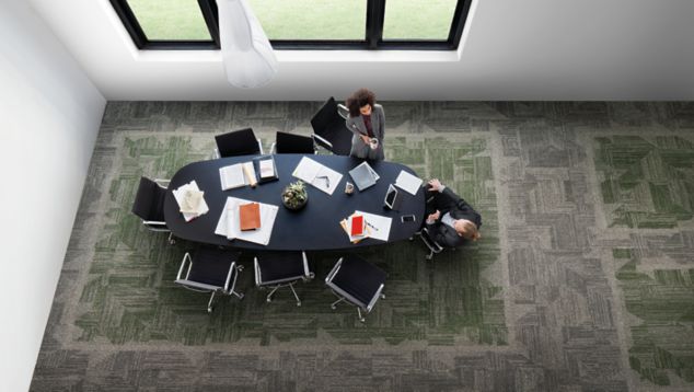 Interface Open Air 403 carpet tile in overhead view of meeting table with man and woman talking