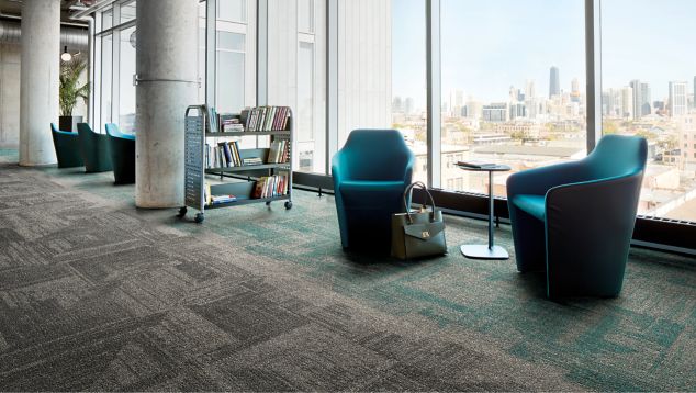 Interface Open Air 403 carpet tile in library with cement columns and city skyline in background through windows