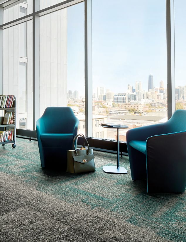 Interface Open Air 403 carpet tile in library with cement columns and city skyline in background through windows