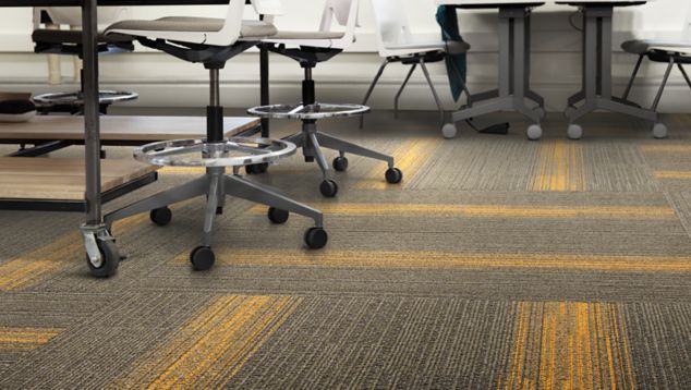 Interface Off Line plank carpet tile with sewing machines at workspaces