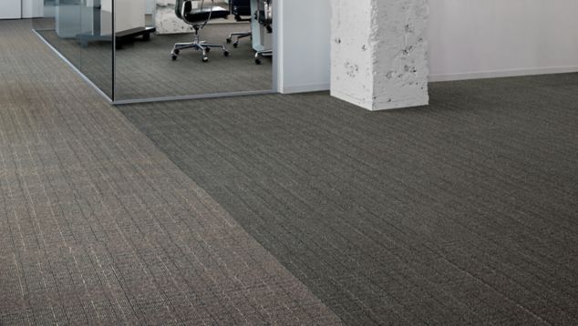 Interface Old Street carpet tile with rough white concrete colum and glass corner office