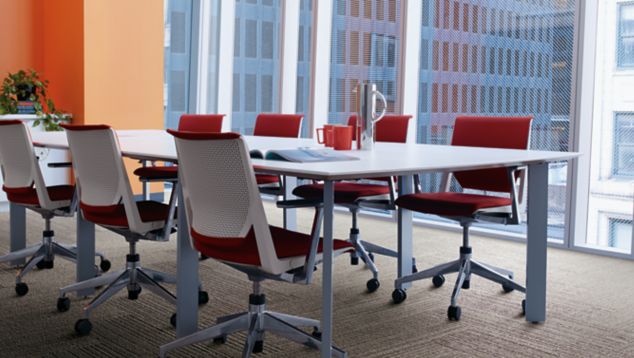 Interface On Line plank carpet tile in meeting room with orange wall and red chairs