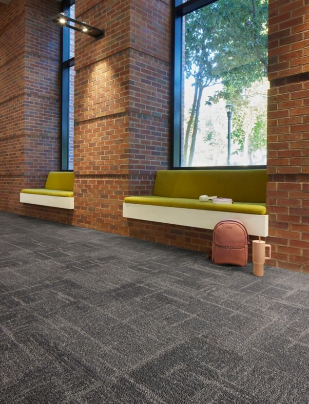 Interface Cornerstones carpet tile in public space seating area with exposed brick