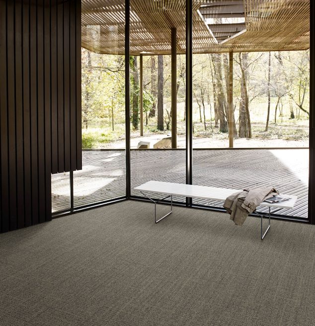 Interface Open Air 401 plank carpet tile with small white bench and wood slat ceiling