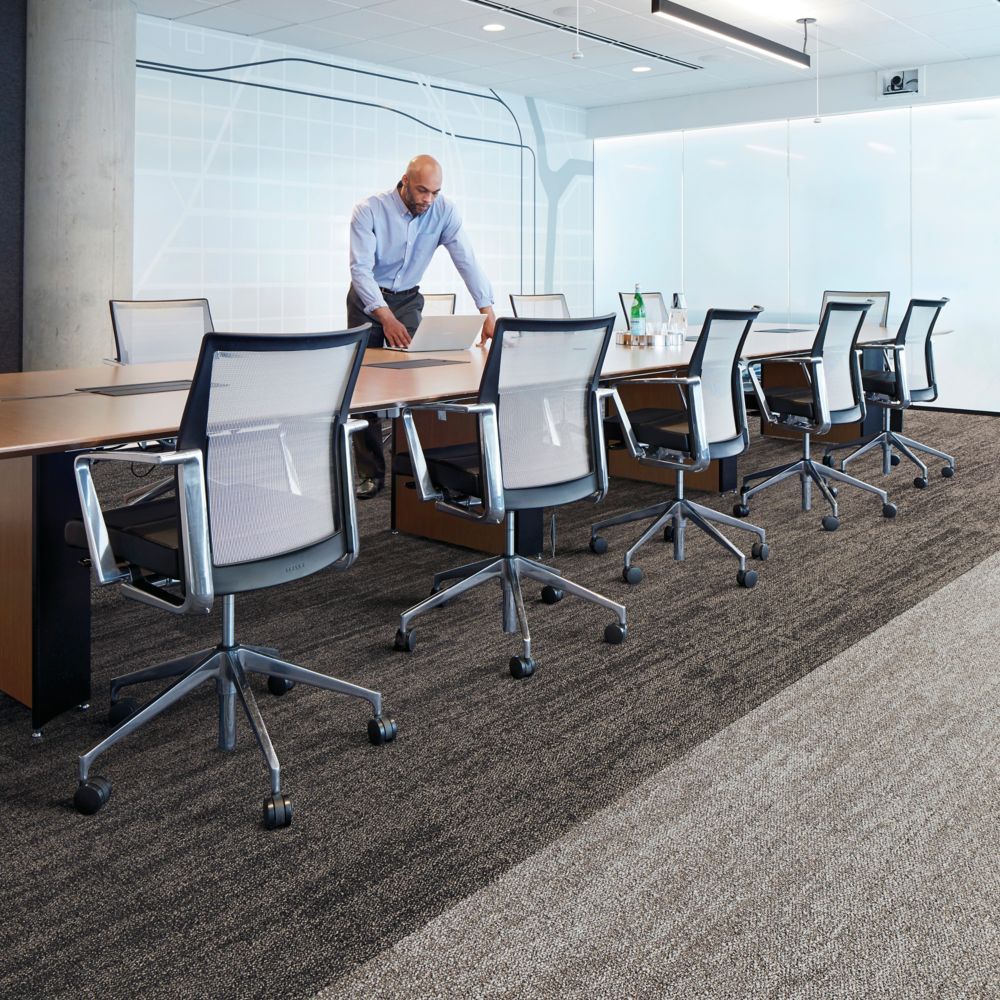 Interface Open Air 402 plank carpet tile with man working on laptop at conference table
