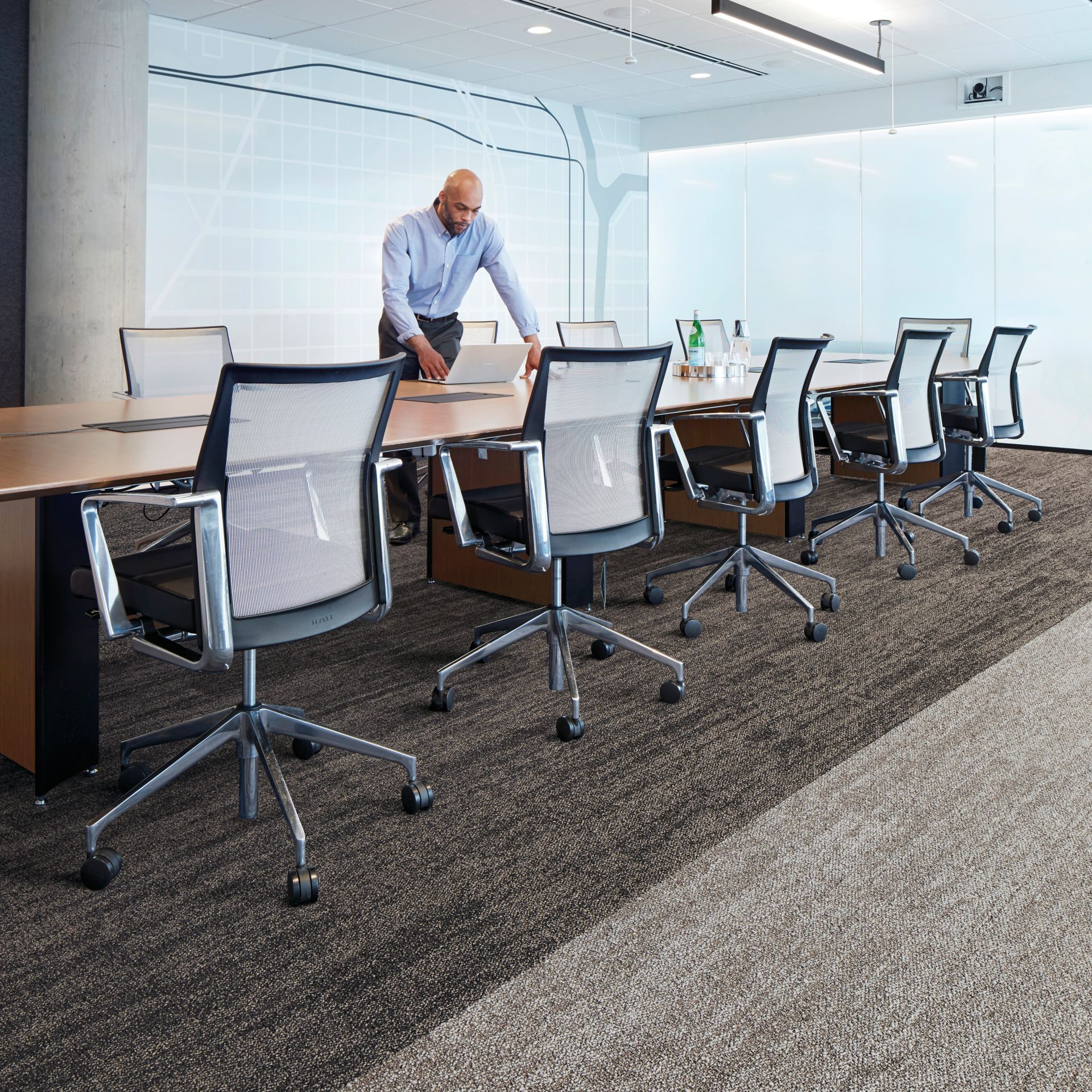 Interface Open Air 402 plank carpet tile with man working on laptop at conference table