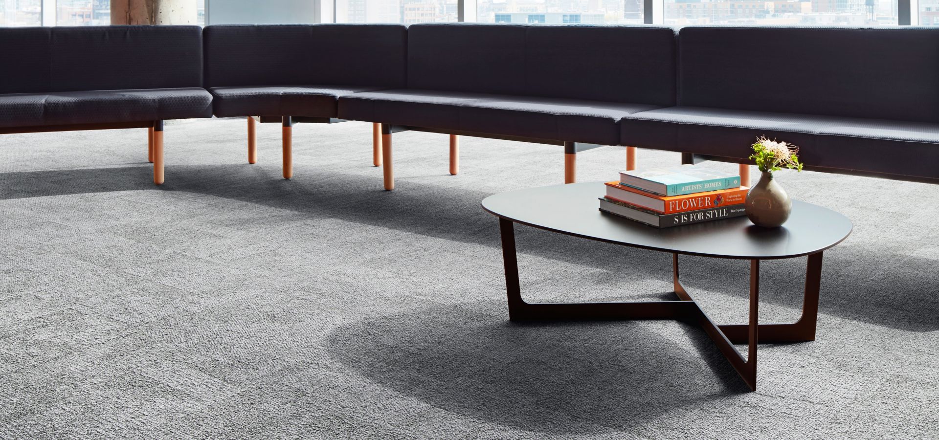 Interface Open Air 404 carpet tile in lounge space with l-shaped seating and coffee table