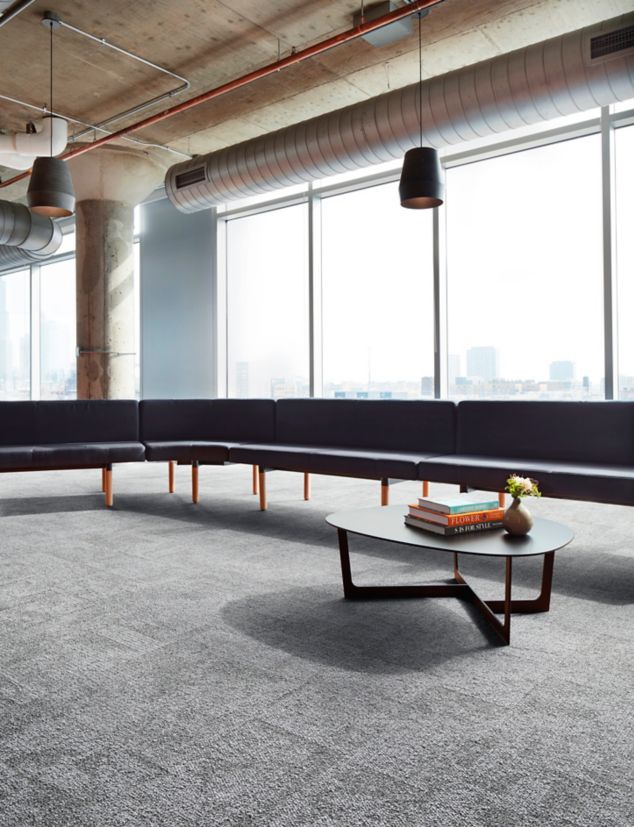 Interface Open Air 404 carpet tile in lounge space with l-shaped seating and coffee table