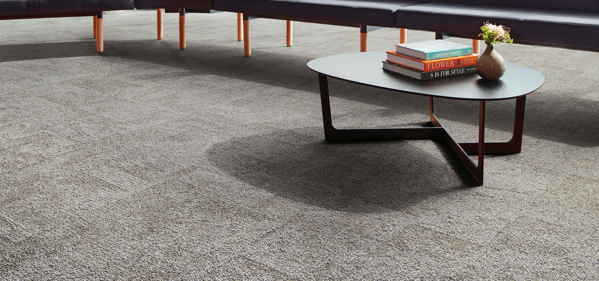 Interface Open Air 404 carpet tile with long sitting bench and books stacked on small table