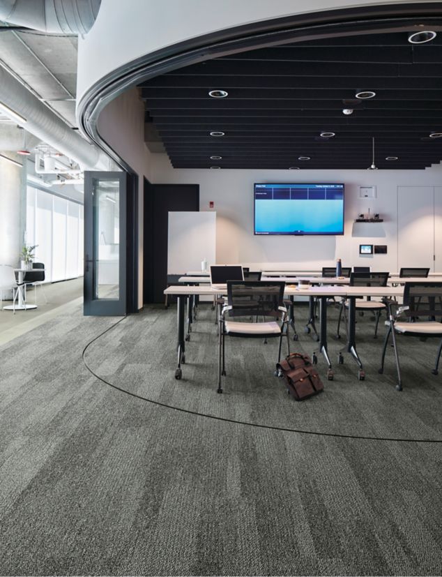 Interface Open Air 410 plank carpet tile in open conference room with satchel leaning on chair