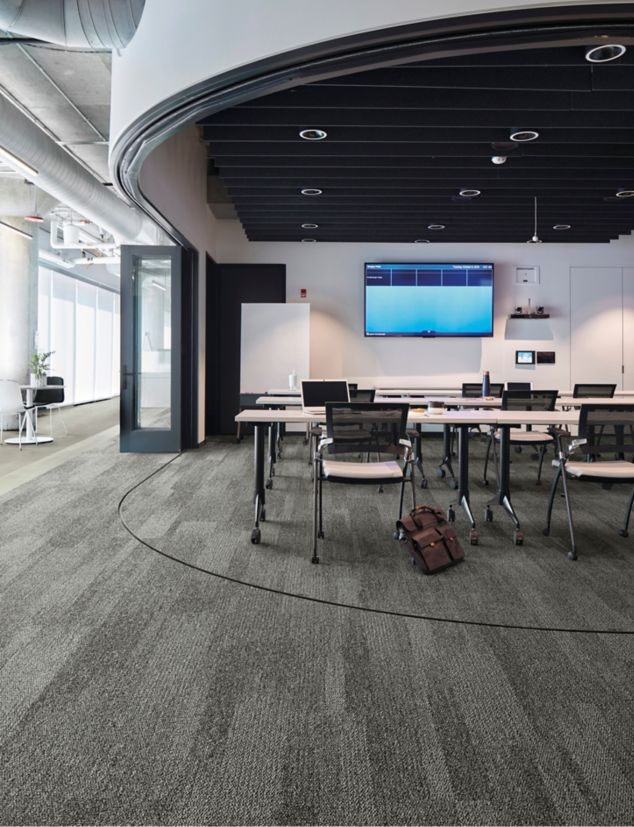 Interface Open Air 410 plank carpet tile in open conference room with satchel leaning on chair