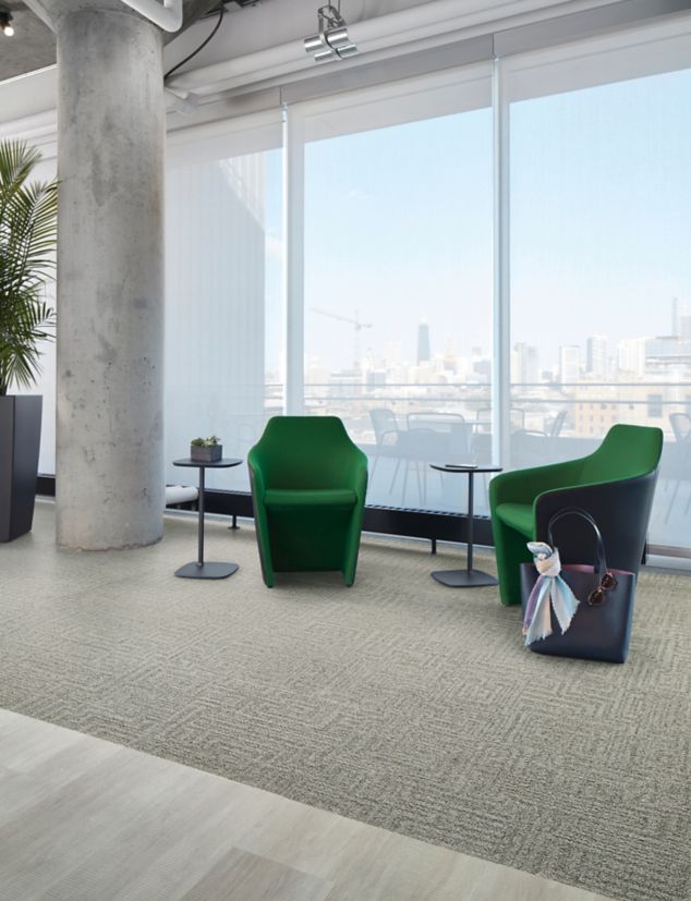 Interface Open Air 413 carpet tile in lounge space with green chairs and cement column