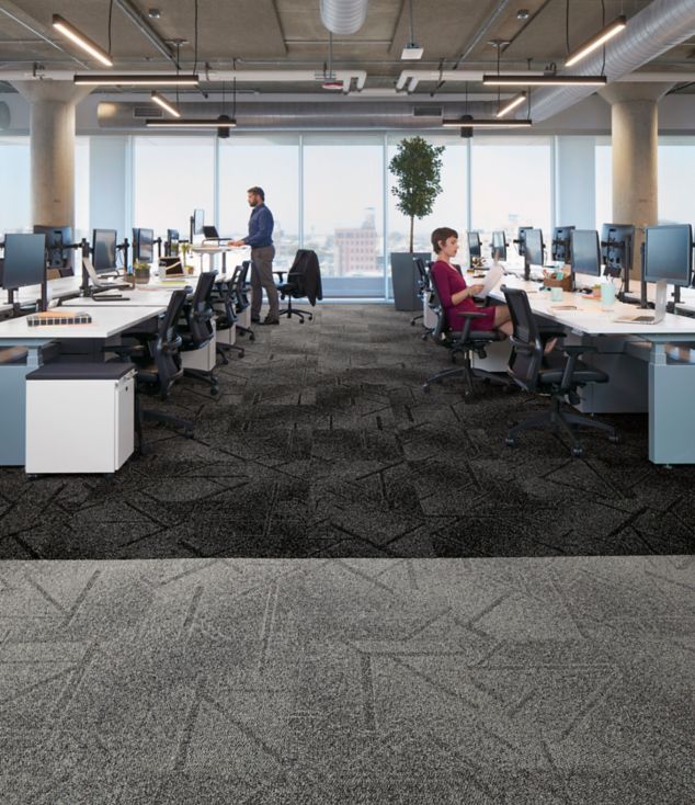 Interface Open Air 417 carpet tile in open workstation area with man working at standing desk