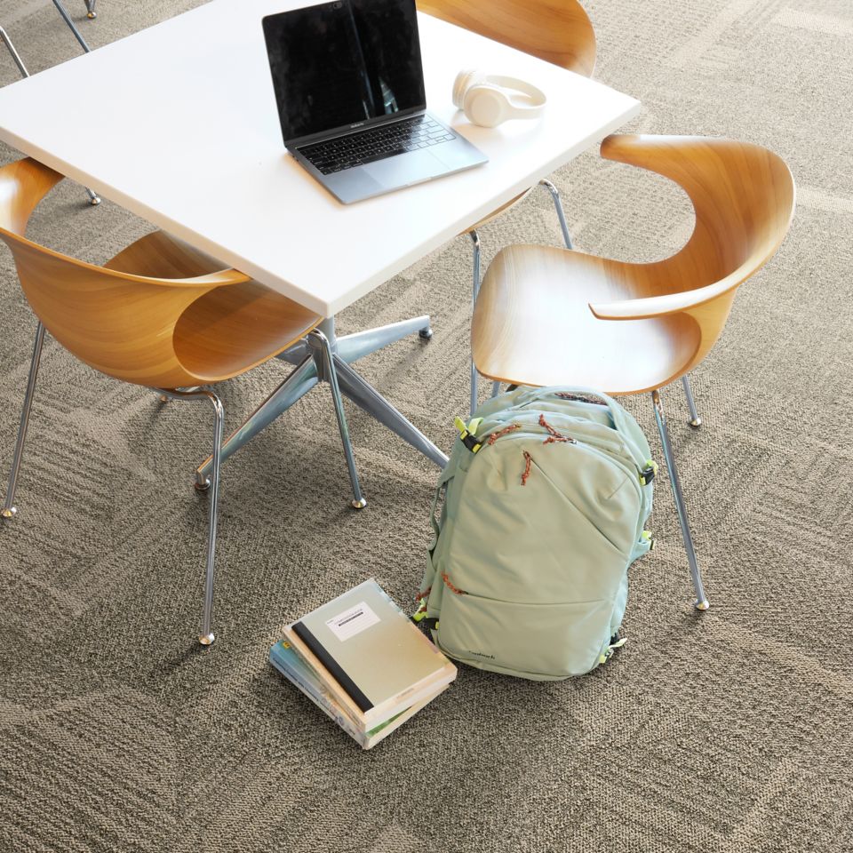 Interface Open Air 441 carpet tile in public space with backpack and laptop
