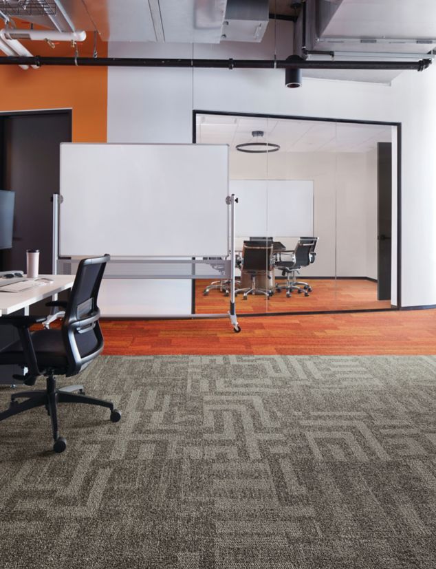 Interface Open Air 414 carpet tile with AE317 plank carpet tile in corner workstation with whiteboard and meeting room in background