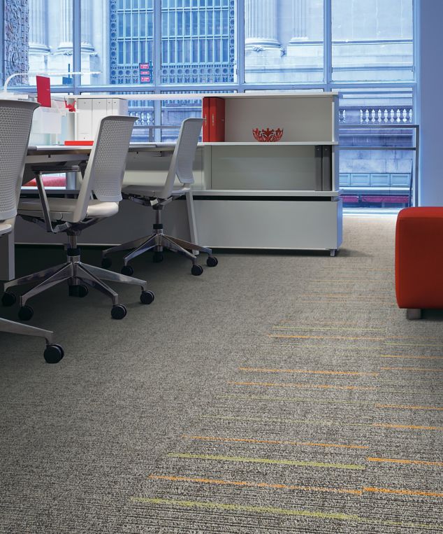 Interface Platform and Sidetrack carpet tile in workspace with red ottoman