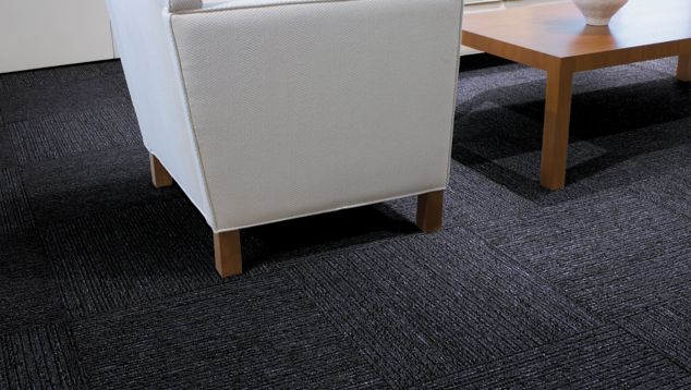 Interface Platform carpet tile in seating area with flowers on wooden table