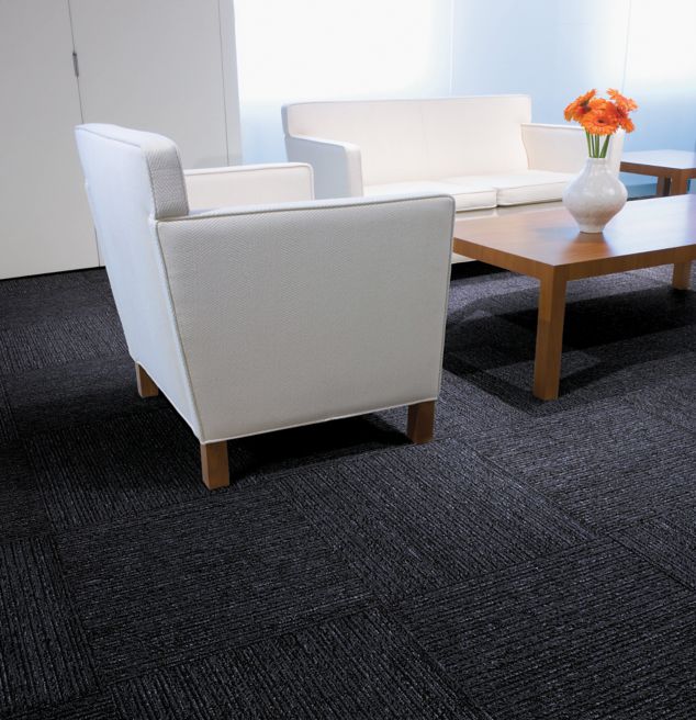 Interface Platform carpet tile in seating area with flowers on wooden table
