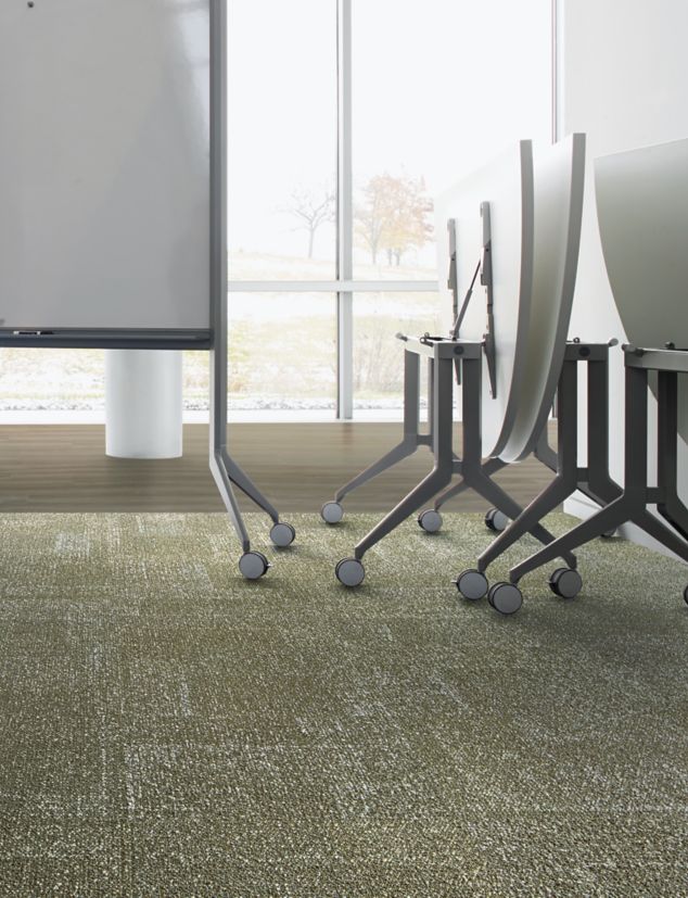 Interface Profile carpet tile and Studio Set LVT in meeting room with chairs and whiteboard