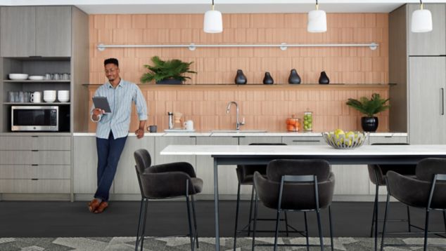 Interface Proportional carpet tile and Brushed Lines LVT in kitchen area with man on tablet