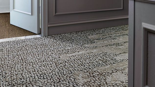 Interface HN840, HN850 and RMS 607 plank carpet tiles in hotel hallway with hotel room door ajar