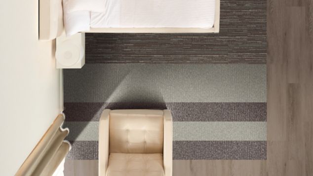 Interface RMS 703 and RMS 702 plank carpet tile with Natural Woodgrains LVT in hotel guest room