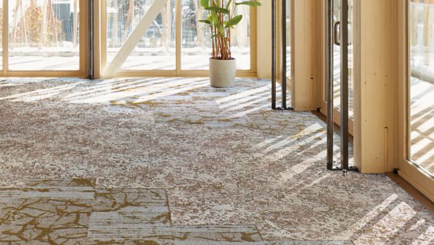 Interface Ground and Raku carpet tile in open space with large windows and natural light