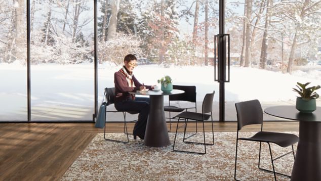 Interface Raku carpet tile and Natural Woodgrains LVT in seating area with man seated