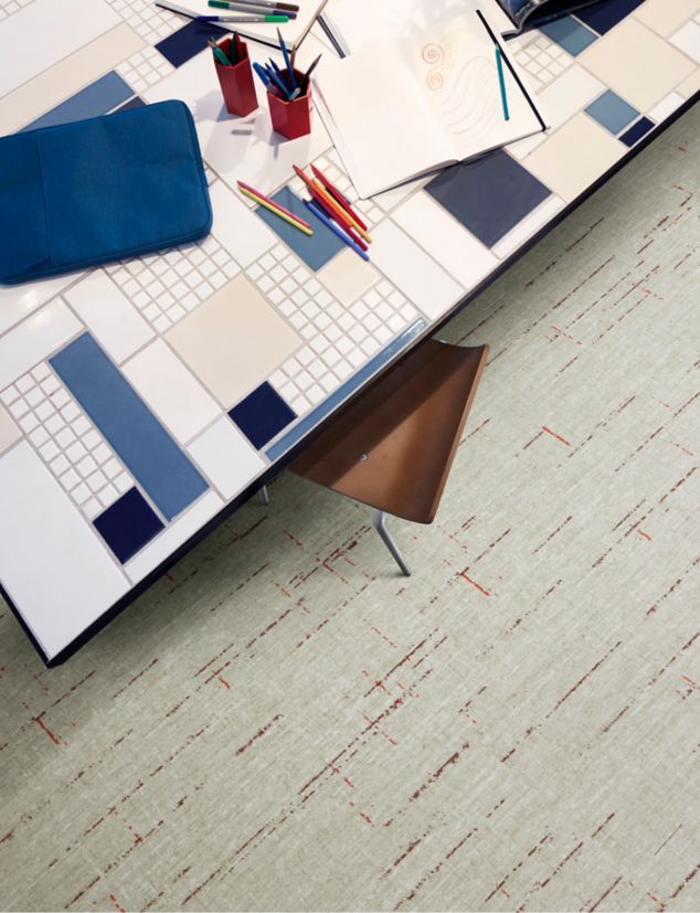Interface Raw Materials plank LVT in Crimson in a collaborative space.