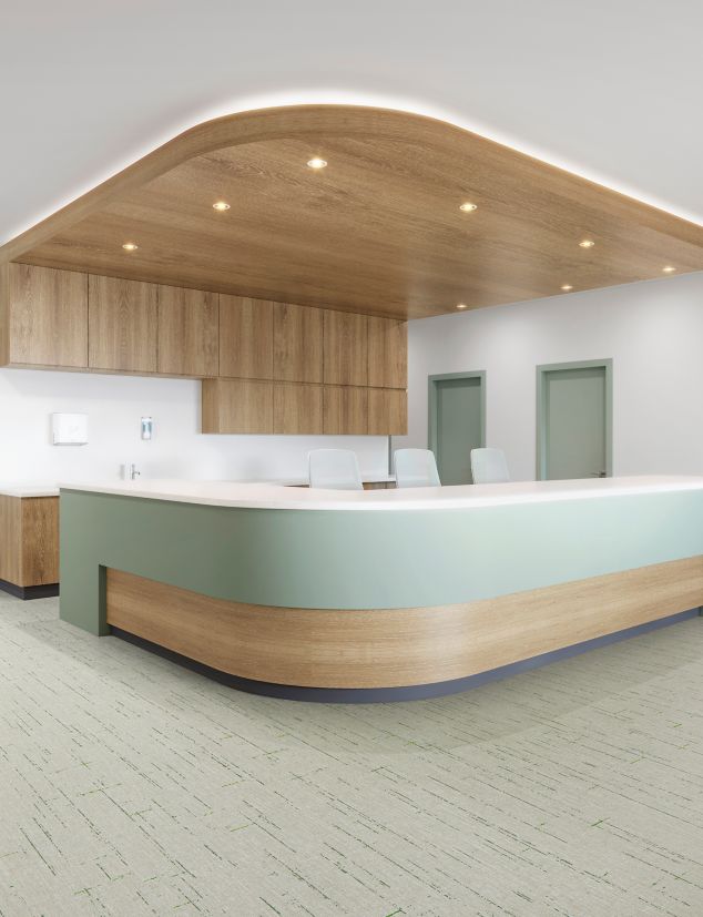 Interface Raw Materials plank LVT in Grass Green in a reception area.