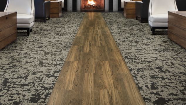 Interface Meadowland carpet tile and Natural Woodgrains LVT in walkway of lounge area with fireplace in background