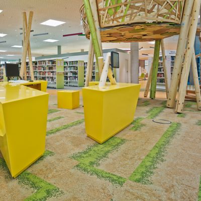 Information desks and book shelves in a public library, equipped with Interface carpet from the Urban Retreat Collection