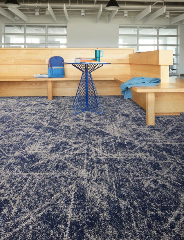 Interface Cosmic Web carpet tile in seating area with small table