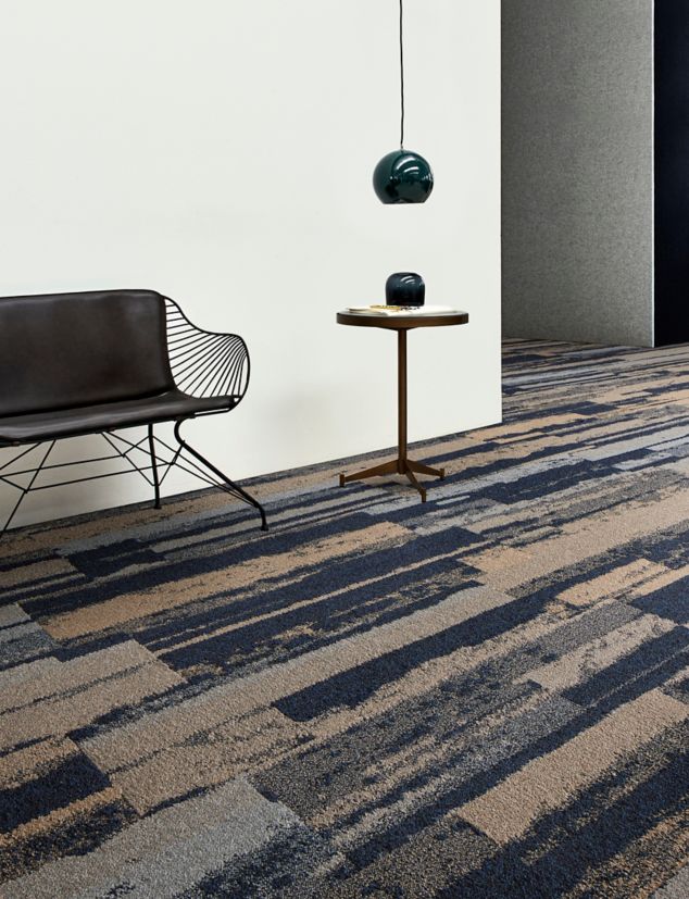 Interface Endless Orbit plank carpet tile in open area with black chair and small table