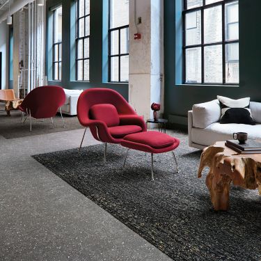 Interface Step Aside, Step This Way, and Walk the Aisle carpet tile in seating area with red chair