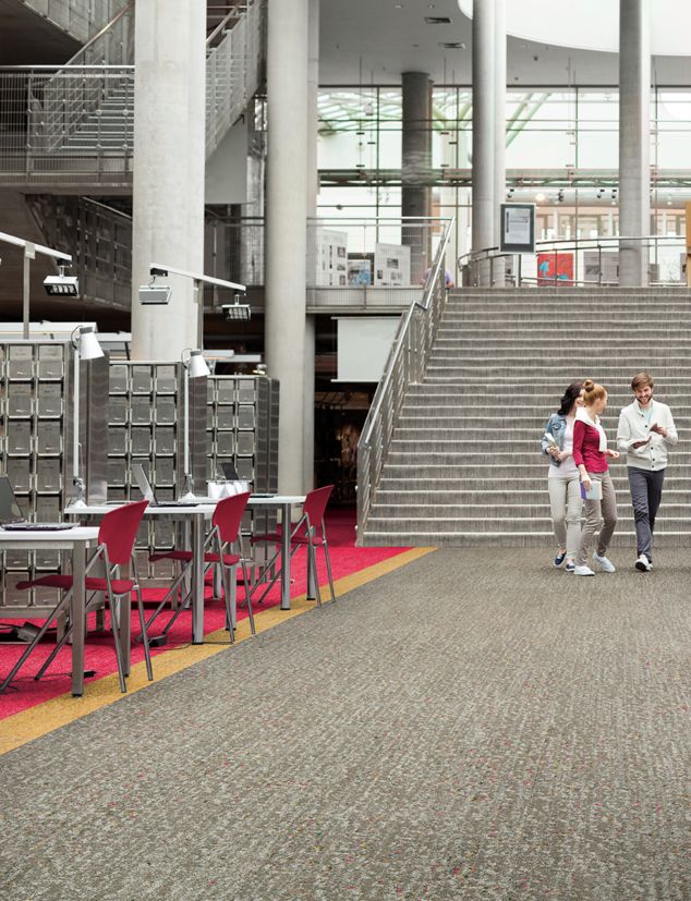 Interface Step it Up and Step Aside carpet tile in open college setting with staircases, tables and shelves