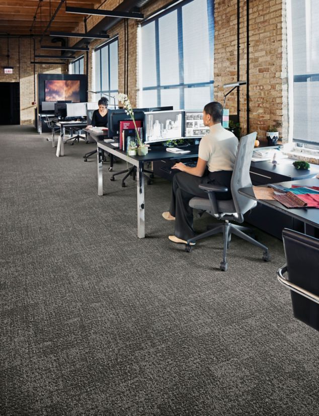 Interface Step in Time carpet tile shown with office cubicles and brick walls