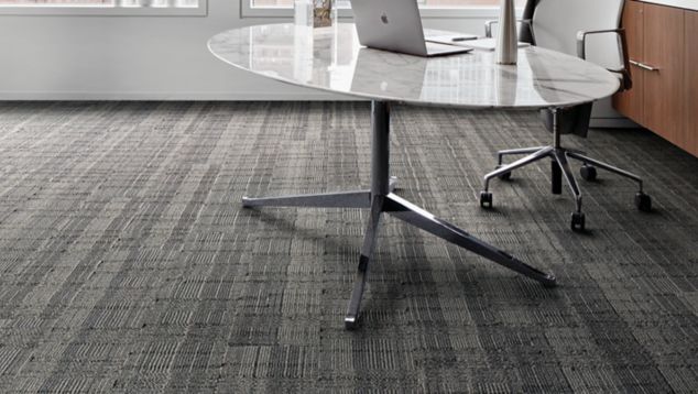 Interface Stitch Count plank carpet tile with table and chair by a window