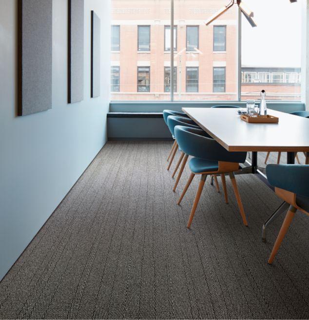 Interface Stitch in Time plank carpet tile in meeting space with wood paneling