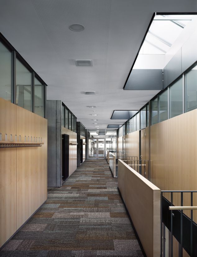 Interface Verticals plank carpet tile in office sky light area with wood paneling