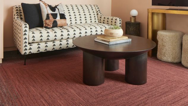 Interface WG100 and WG200 carpet tile in waiting area with round table and tv