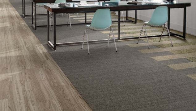 Interface WW860 and WW895 plank carpet tile in open work area with teal chairs